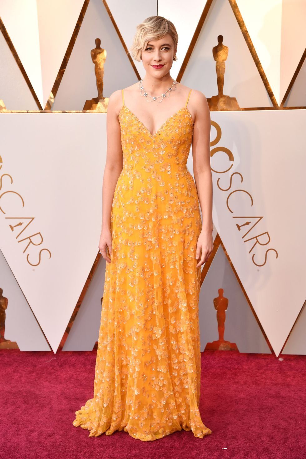 Red carpet, Carpet, Dress, Clothing, Gown, Yellow, Shoulder, Flooring, Fashion, Hairstyle, 