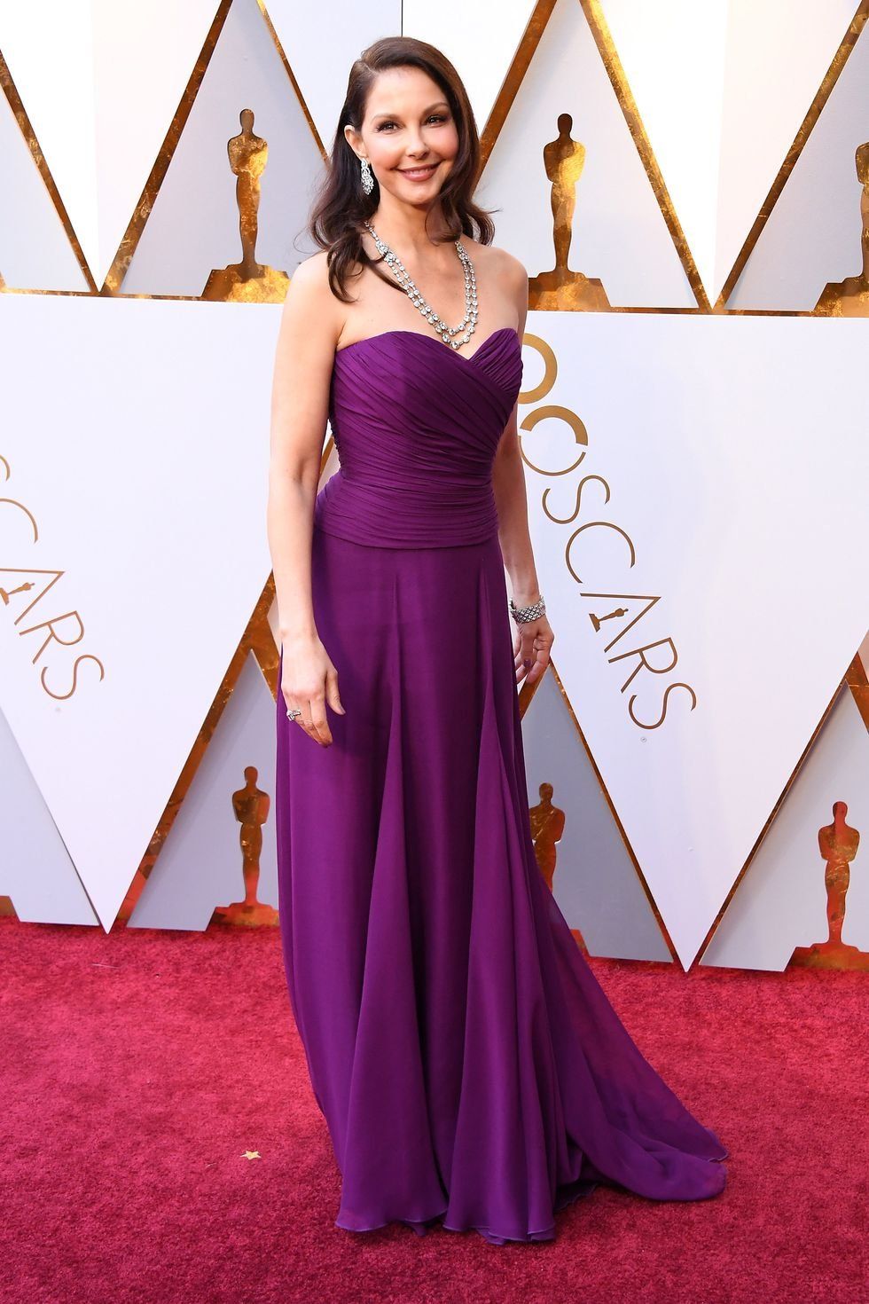 Red carpet, Carpet, Dress, Clothing, Shoulder, Gown, Purple, Flooring, Fashion, Hairstyle, 