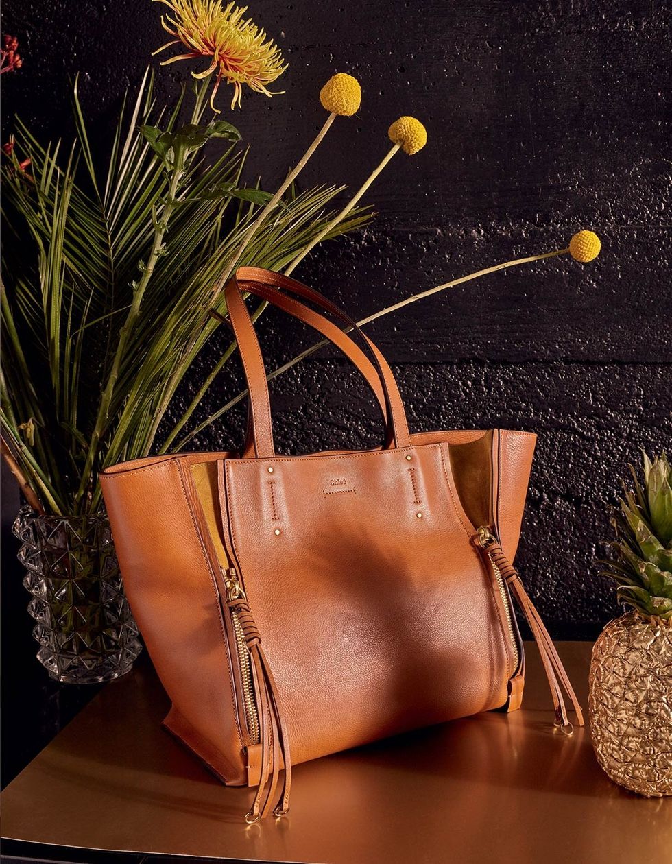 Bag, Shoulder bag, Tan, Still life photography, Leather, Luggage and bags, Flower Arranging, Floral design, Flowering plant, Houseplant, 