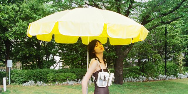 Umbrella, Yellow, Grass, Fashion accessory, Summer, Shade, Tree, Vacation, Leisure, Photography, 