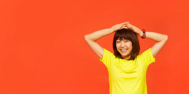 Yellow, Orange, Shoulder, Arm, T-shirt, Standing, Neck, Joint, Gesture, Human body, 