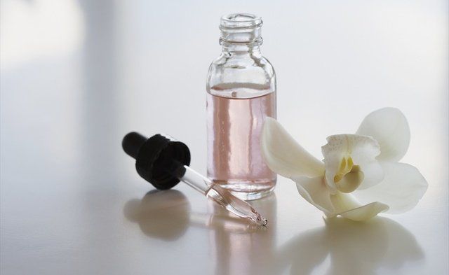 Bottle, Glass, Petal, Drinkware, Still life photography, Glass bottle, Chemical compound, Artificial flower, Transparent material, Cut flowers, 