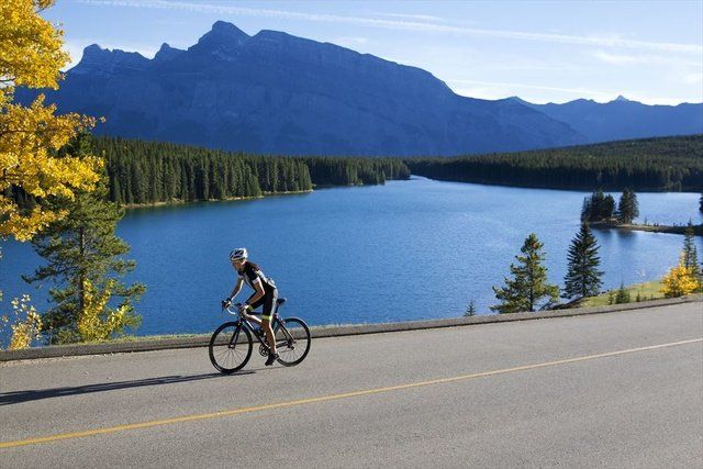 Cycling, Lake, Vehicle, Bicycle, Recreation, Wilderness, Mountain range, Mountain, Sky, Cycle sport, 