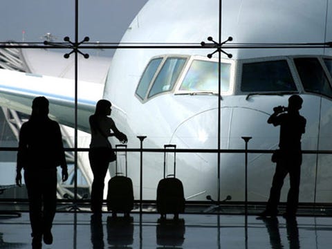 Long Distance Love people standing an airport with a plane outside the window