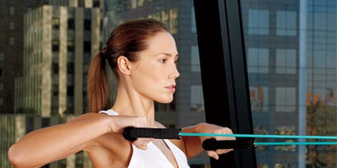 Power Up woman working out in front of window with view of city