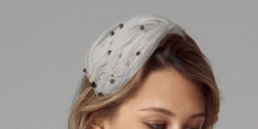Hairstyle Handbook woman with dark blond shoulder length hair and vintage hat