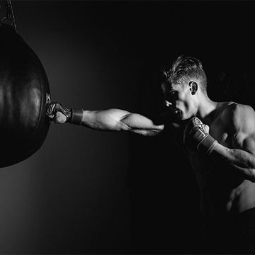 Black, Boxing glove, Boxing, Punching bag, Arm, Muscle, Photography, Flash photography, Black-and-white, Hand, 