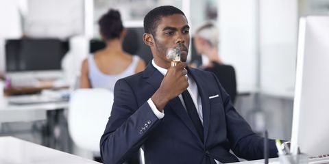 Man smoking e-cigarette in office