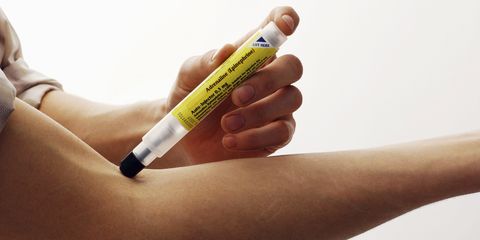 man using epipen injection
