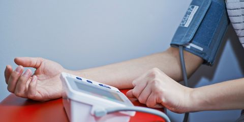 woman measuring her blood pressure