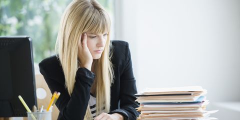 Woman looking sad at her desk