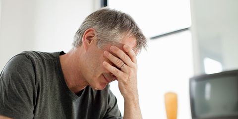 A man feeling depressed with head in hands