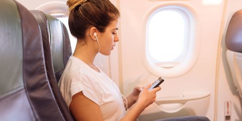 woman on plane travelling to holiday destination