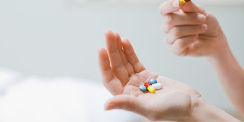 Multicoloured pills in hand