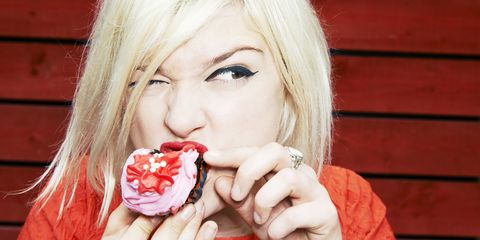 A woman eating a cupcake