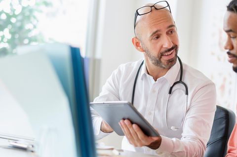 doctor and male patient in gp surgery