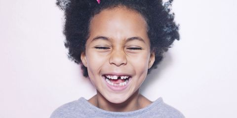 Smiling child with missing tooth