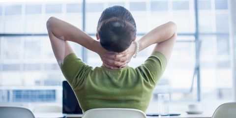 Woman sitting at desk with sore neck