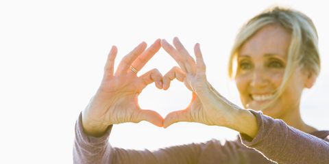 woman making heart shape with hands