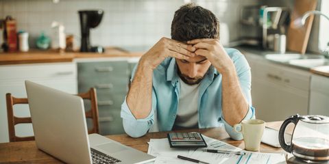 Man feeling stressed sat at computer