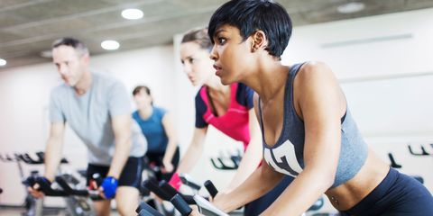 Woman in spinning class on exercise bike