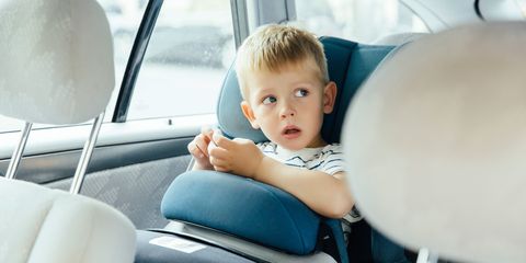 Little boy sitting in his car seat