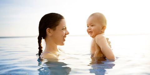 Mother and baby in pool on holiday