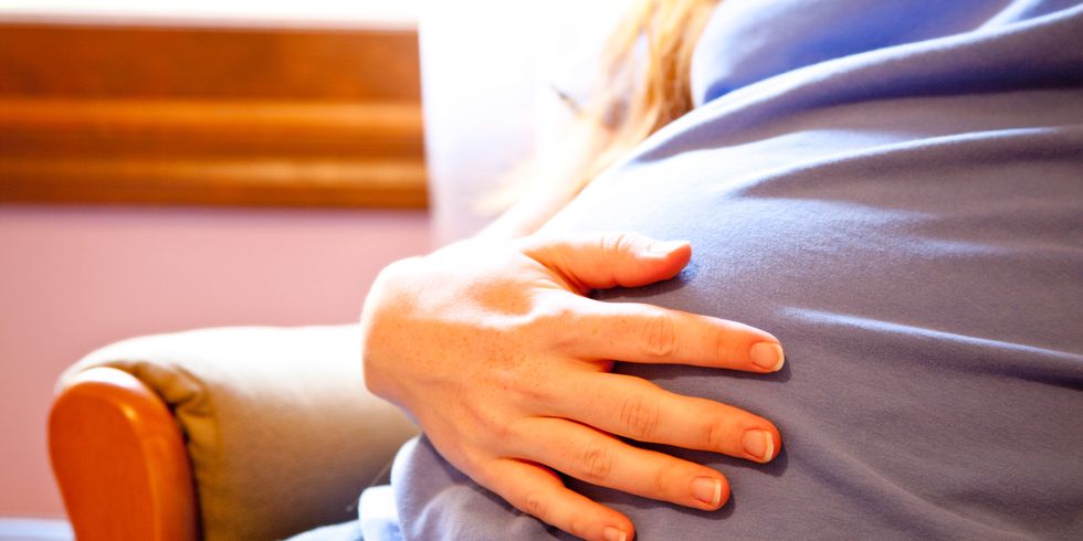 Pregnant woman hand on stomach