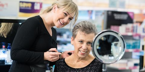 make up artist doing the make up of someone undergoing cancer treatment