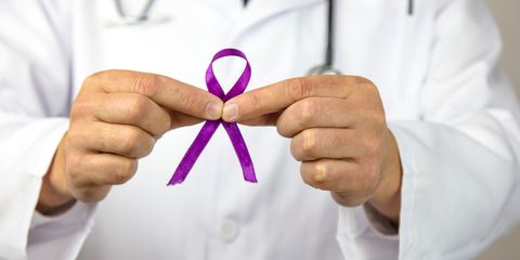 Doctor holding breast cancer ribbon