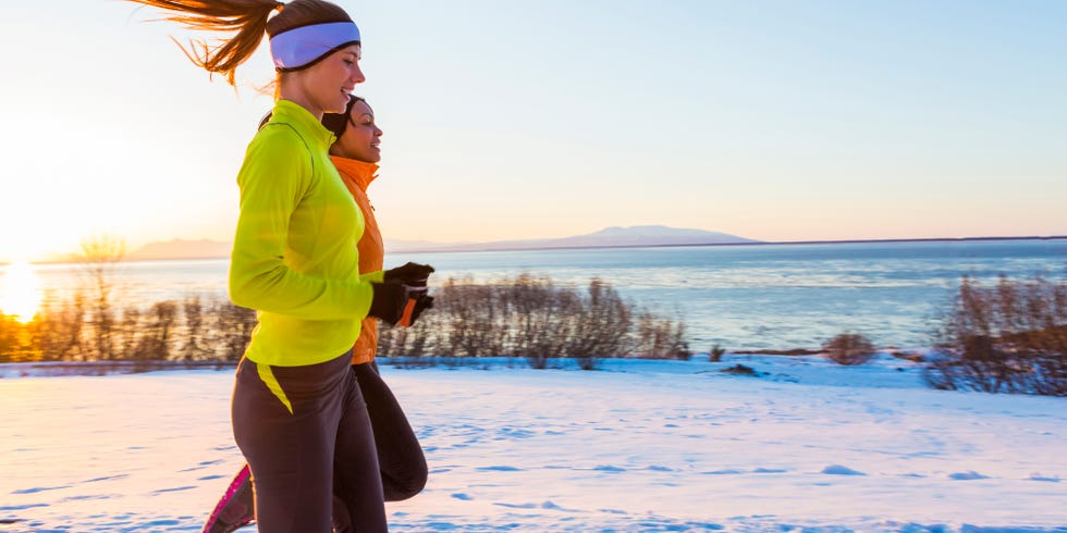 Women running on snow in winter