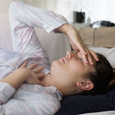 Woman feeling sick at home can't get up off sofa
