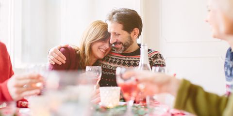 Couple hugging at family Christmas party