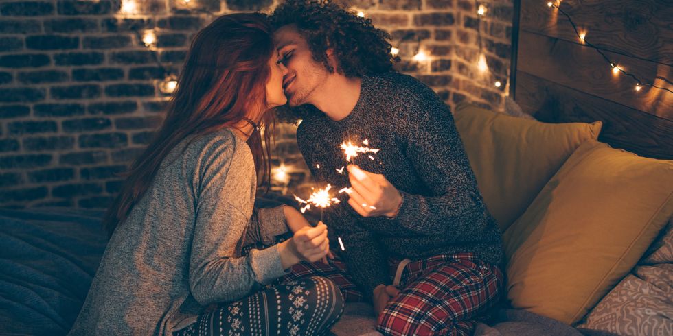 Couple kissing with sparklers