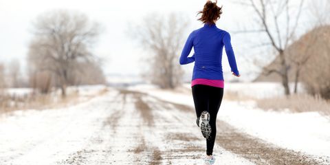 Woman running in snow winter