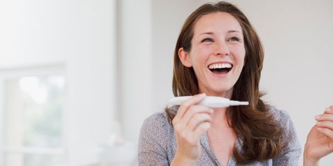Woman happy with pregnancy test