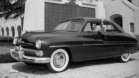Gary Cooper (1901 - 1961), American leading man and long-enduring Hollywood star, in his 1949 Mercury Sedan with white-walled tires. (Photo via John Kobal Foundation/Getty Images)
