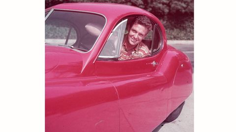 circa 1955: American actor Robert Stack (1919 - 2003) smiles while looking out from the driver's seat of a Jaguar XK120 fixed-head coupe. (Photo by Hulton Archive/Getty Images)