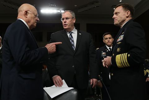 Director of National Intelligence James Clapper, left, speaks with Deputy Defense Secretary Robert Work and Adm. Michael Rogers at a Senate Armed Services Committee hearing on cybersecurity.