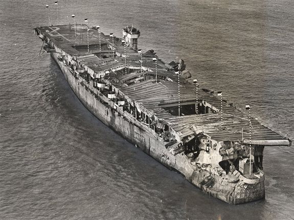 The USS Independence arriving in San Francisco after atomic testing in Bikini Atoll. The damage seen is entirely a result of the nuclear blast.
