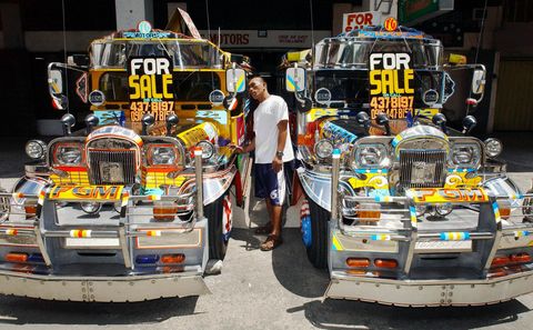 A buyer checks out a 22 passenger jeepney for sale at a shop in Manila, 01 July 2003. The locally made jeep made mostly of stainless steel body and a second hand Japanese diesel engines sells for 370,000 pesos (7,400 USD). The jeep is the Philippines popular means of public transport.. Jeep builders use popular and very bright and colorful designs to make it look attractive in the street