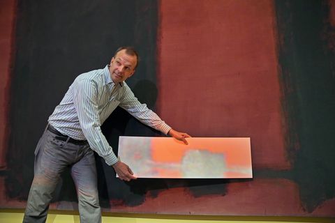 Jens Stenger, formerly a conservation scientist in the Straus Center for Conservation and Technical Studies at the Harvard Art Museums and now a conservation scientist in the Institute for the Preservation of Cultural Heritage at Yale University, places a white card in front of a Mark Rothko painting ('Panel Four 1962') to show the color differences that are projected from above. Harvard Art Museums are about to reveal what they hope will be a revolutionary new way to restore paintings - through light projections. The museums will unveil a group of Rothko paintings kept in storage for decades because of light damage.