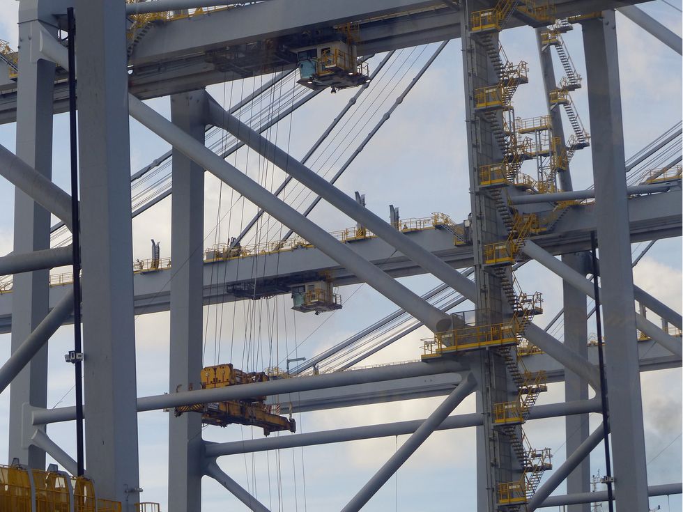 <p>Containers are lifted off the ship two at a time&nbsp;by quay cranes, 450-foot-high behemoths with booms long enough to reach across the width of the ship .</p><p><br></p><p>The cranes at London Gateway are the largest in the world&nbsp;and were imported from China by the Zhen Hua, a special transport ship <a href="http://onthethames.net/2016/07/01/huge-cranes-arrive-london-gateway/">which carries assembled cranes in one gigantic&nbsp;piece</a>. Each of the 2,000-ton cranes runs on rails supported by foundations driven 150 feet into the ground.&nbsp;The operators sit in cabs high above.&nbsp;</p><p><br></p><p>When unloading these ships, it's better to have good motor skills rather than brute strength.</p>