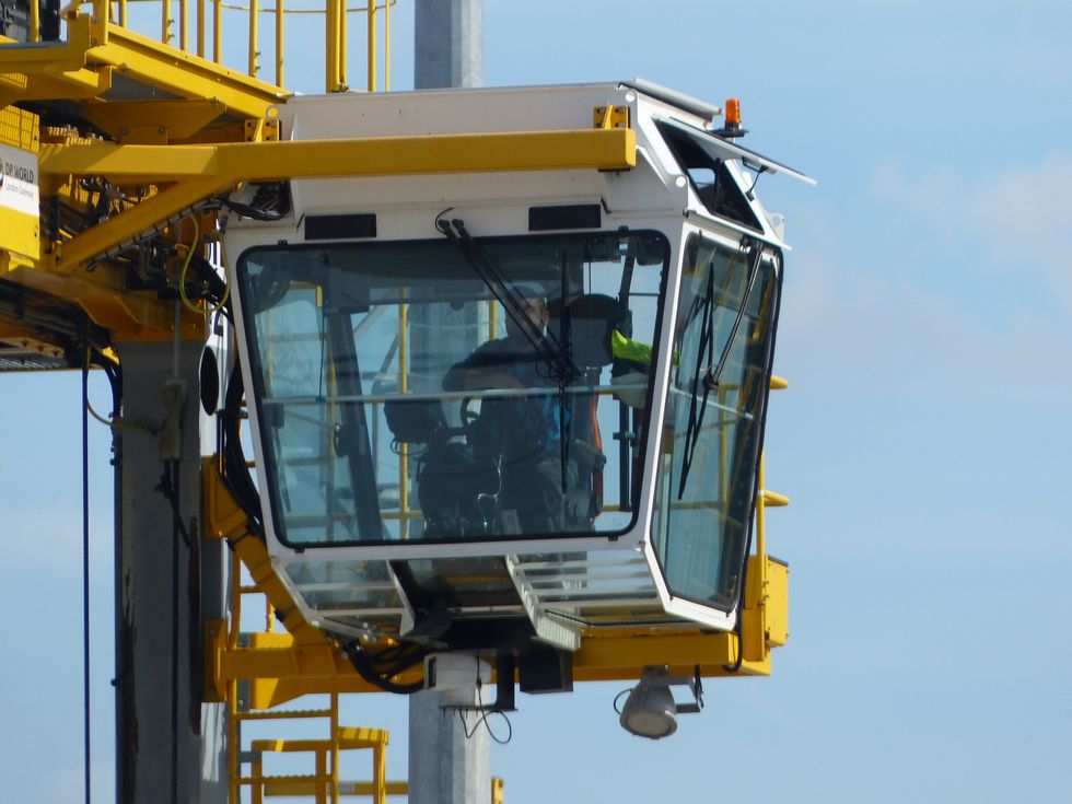 <p>Once placed on the quay, the containers are picked up by a fleet of giraffe-like vehicles known as shuttle carriers (GIF above). A shuttle carrier can pick up two TEUs at once, with a hydraulic lift to move and stack them.</p><p><br></p><p>The current loaders are hybrid diesel-electric vehicles with regenerative braking, a useful feature for machines&nbsp;constantly stopping and starting.</p>