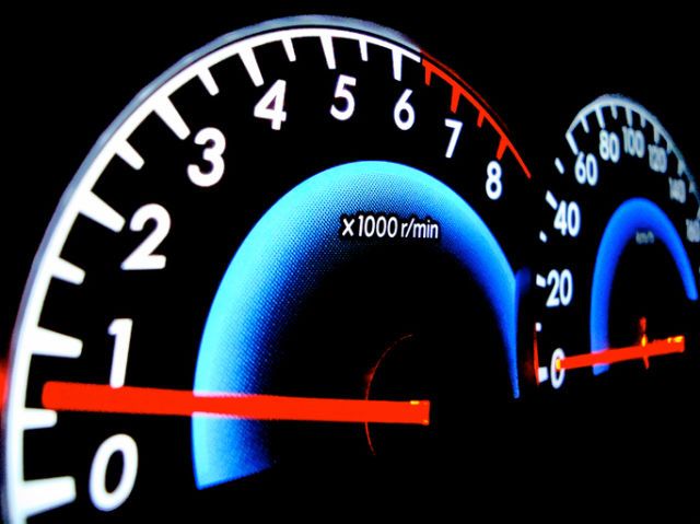 Analog speedometer of a car showing round per minute indicator and velocity indicator.