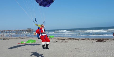 Just A Bunch Of Santas Skydiving Onto Beach Santas Skydiving Onto A Beach