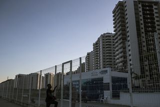 A worker arrives at a Companhia Estadual de Aguas e Esgotos (CEDAE) plant, built to help maintain the Olympic Village. The luxury apartments that were promised have yet to arrive.
