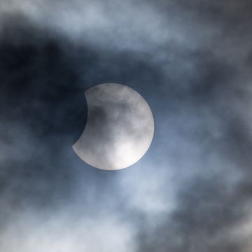 partial solar eclipse cloudy skies