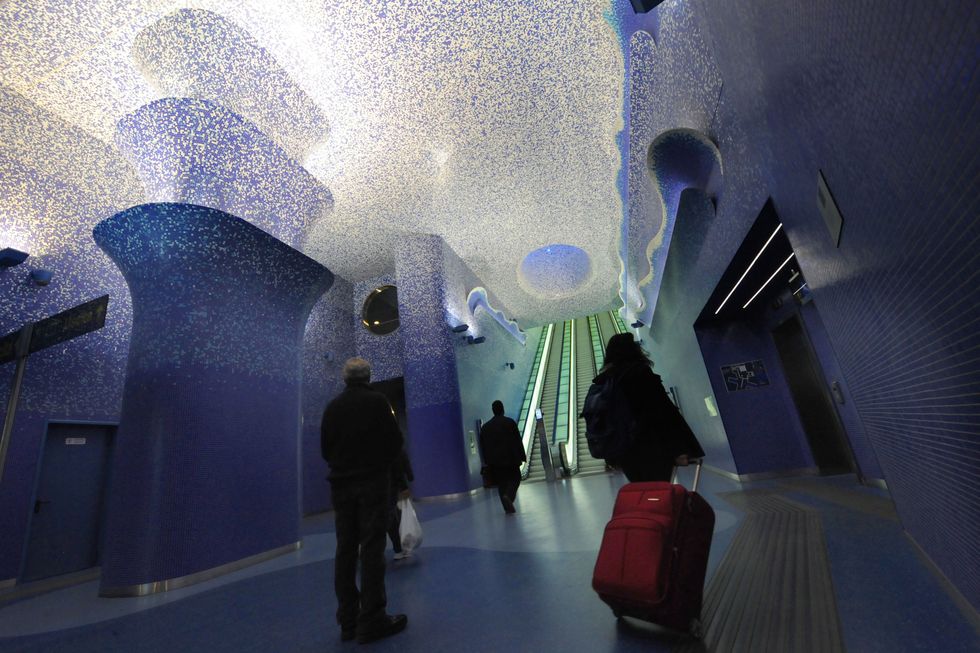<p>One of the deepest stations in the Naples subway line is also one of the most visually spectacular. Opened in 2012, the Toledo Metro Art Station features a multi-level construction that integrates the remains of walls from the Aragonese period in the late 1400s and includes a blue mosaic that grows more intense as visitors descend. The subterranean lobby connects with the popular district above via natural light streaming in through cones in hexagonal patterns.<span class="redactor-invisible-space" data-verified="redactor" data-redactor-tag="span" data-redactor-class="redactor-invisible-space"></span></p>