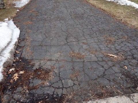 asphalt driveway with spiderweb or alligator cracks